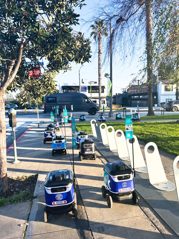 Charles Schwab branded R-Kiwi robots on a Los Angeles sidewalk
